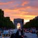 crowded street with cars along arc de triomphe