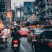 crowded street with cars passing by